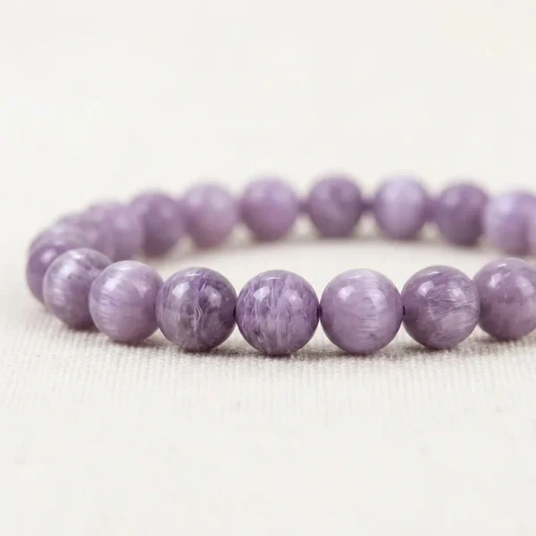 Close-up of Kunzite Energy Bracelet showing natural purple veining in round polished crystal beads.