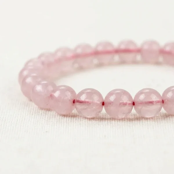 Close-up of Rose Quartz Energy Bracelet showing smooth polished pink crystal beads with natural clarity.