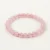 Rose Quartz Energy Bracelet with soft pink translucent beads on cream linen background.
