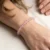 Rose Quartz Energy Bracelet worn on woman's wrist, delicate pink gemstone beads on soft background.