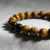 Close-up of Yellow Tiger's Eye bracelet showing golden-brown chatoyant beads.